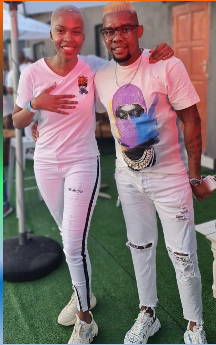 Pair in pink mascot tee and ski-mask graphic tee.